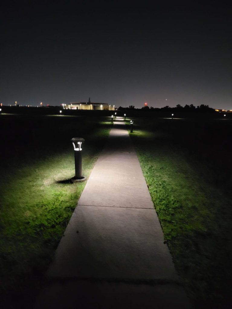 SolarPath solar bollard lights illuminating a concrete pathway at night
